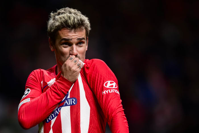 Antoine Griezmann pictured kissing the Atletico Madrid crest on his jersey after scoring a goal in a 2-0 win over Lazio in December 2023
